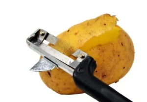 potato is peeling off by peeler