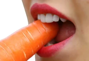 women eating a carrot with teeth